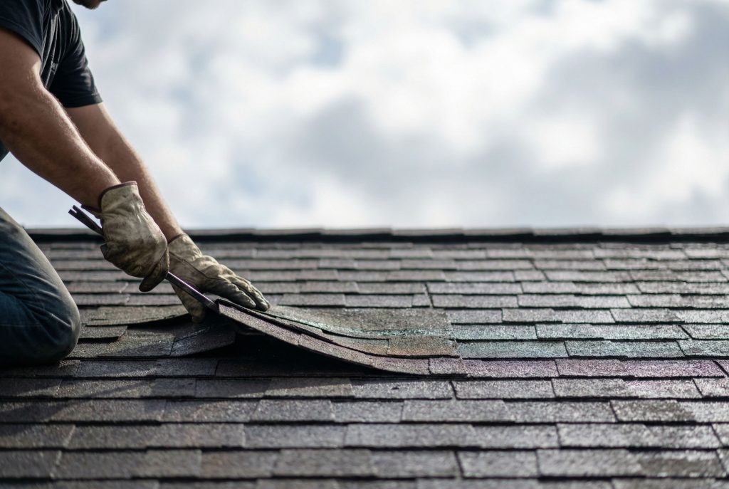 Roof repair in Gainesville, FL—replacing damaged asphalt shingles